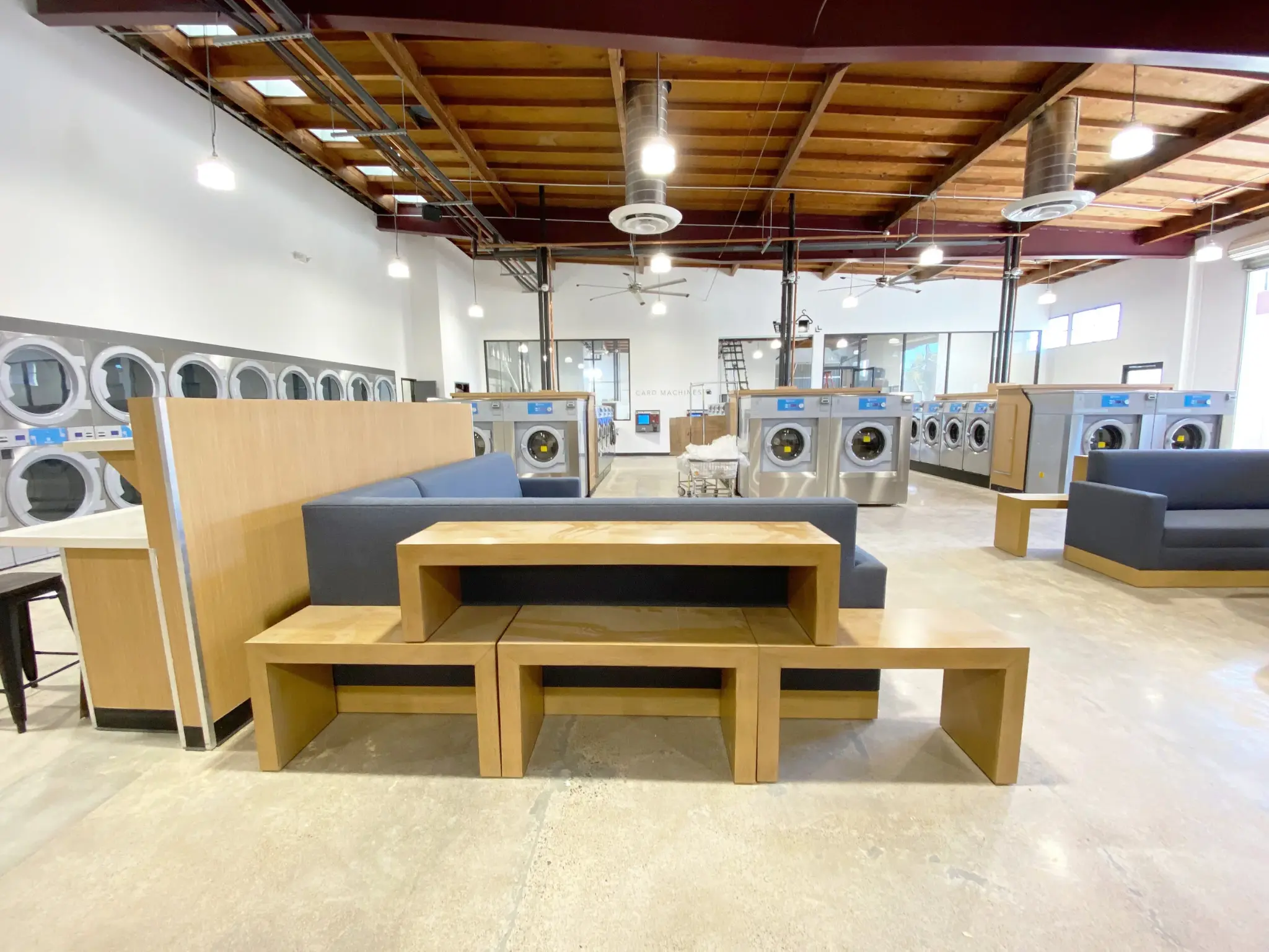Lucy's Laundry wide interior showing soaring wood beam ceilings and spacious layout