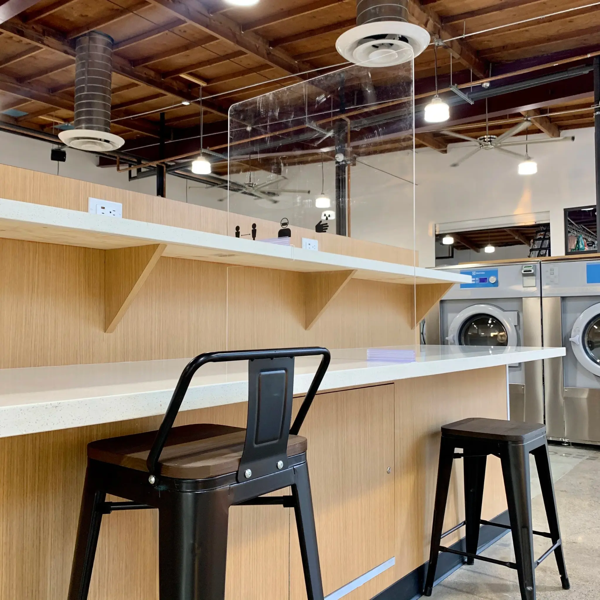 Bar counter with charging stations at Lucy's Laundry Costa Mesa